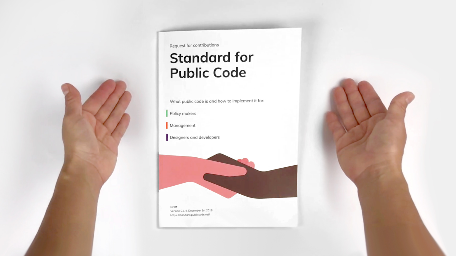 Thumbnail for the video on the Standard for Public Code: a printed version lying on a table between two hands
